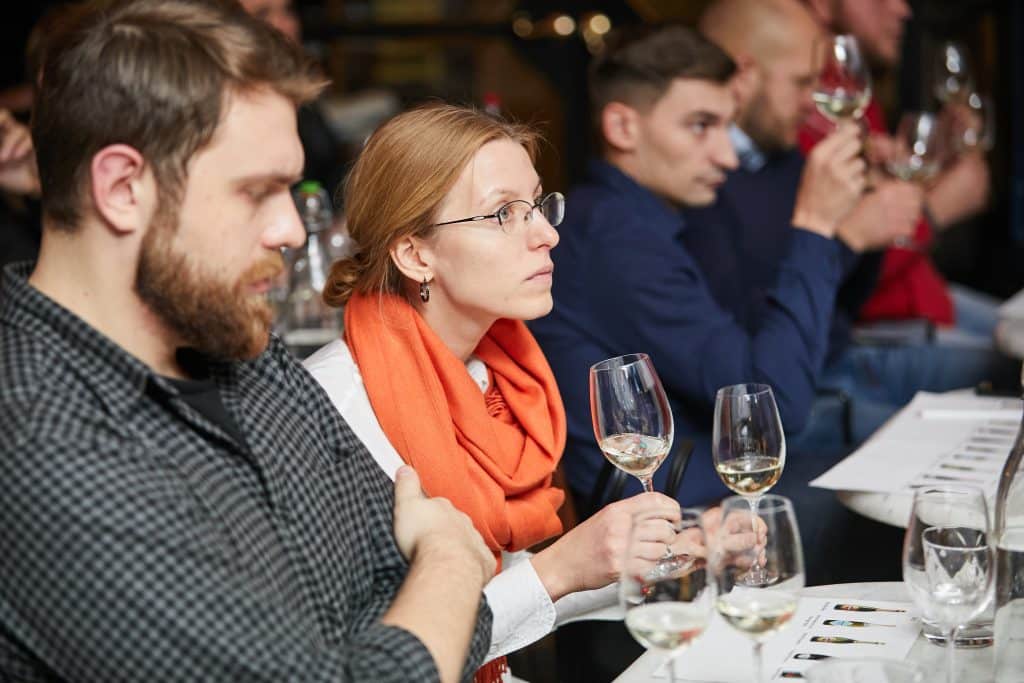 People tasting wine at an event.