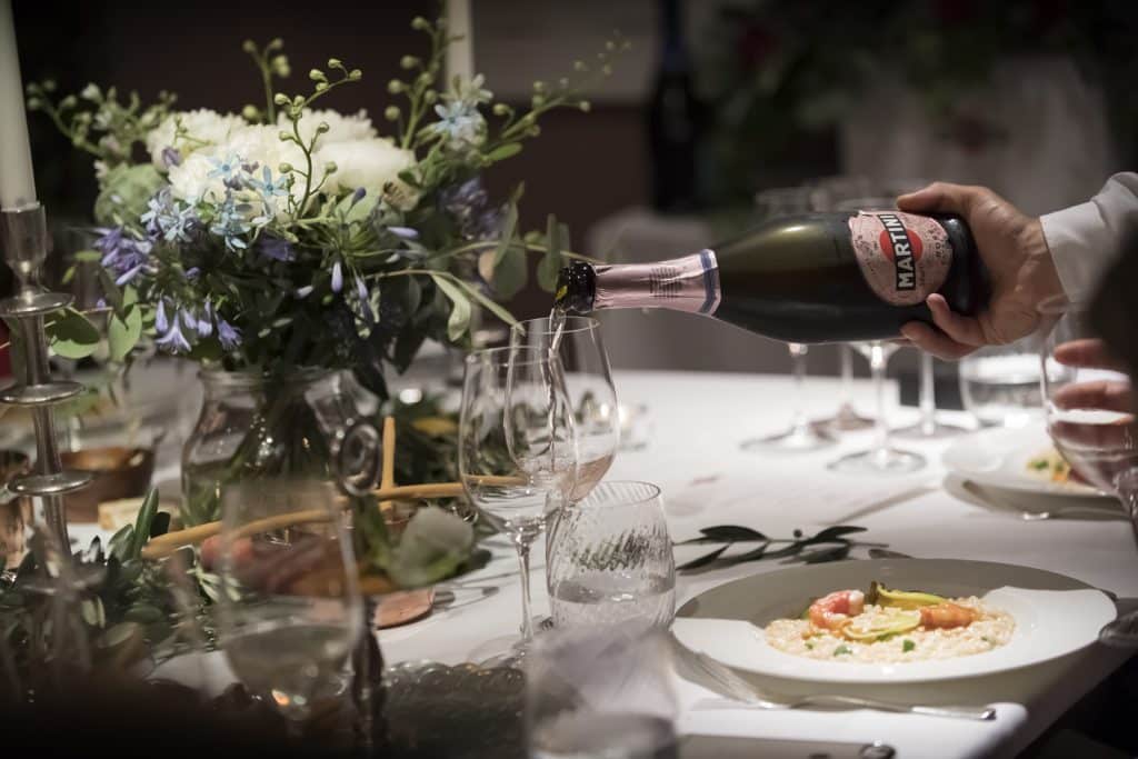 Elegant dining with champagne and flowers.