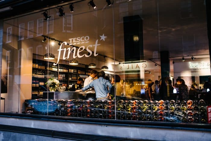 Modern wine bar with customers browsing.