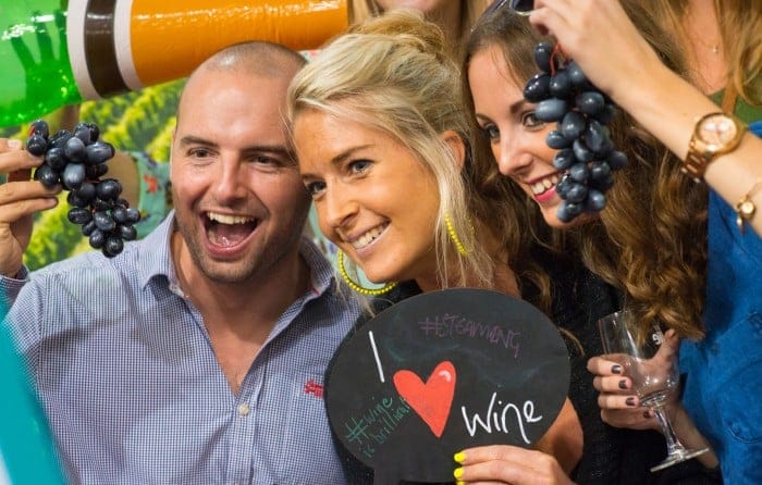 Friends enjoying wine and grapes